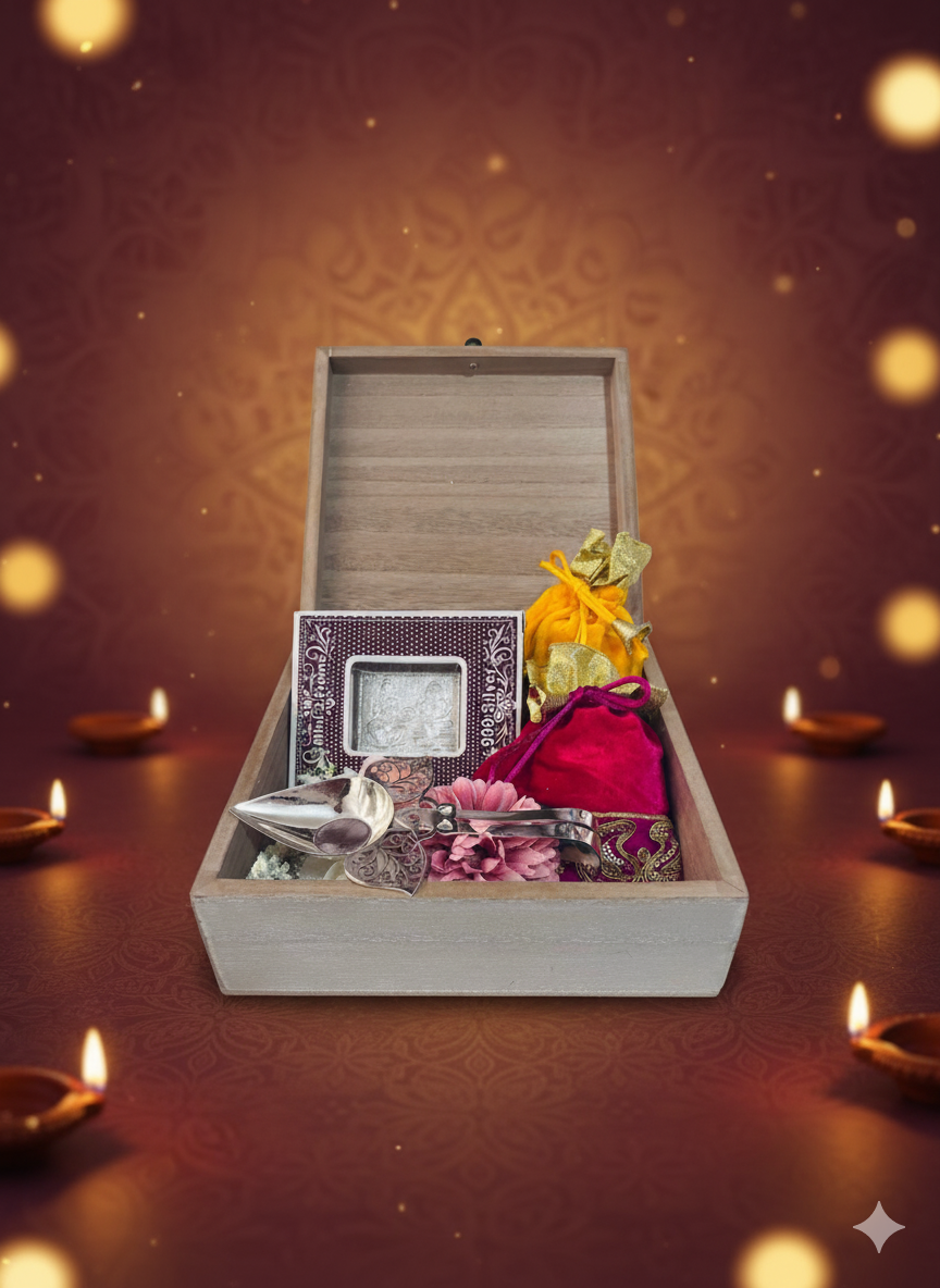 Blossom Hampers Silver Blessing Hamper with Pure Silver 999 Lakshmi Ganpati frame, Divine Aarti Spoon, and potlis in a distressed wooden box.